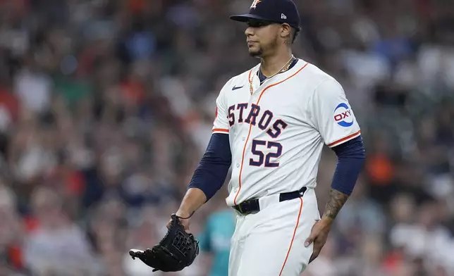 Houston Astros pitcher Bryan Abreu walks to the dugout after blowing a save during the eighth inning of a baseball game against the Seattle Mariners, Sunday, May 5, 2024, in Houston. (AP Photo/Kevin M. Cox)