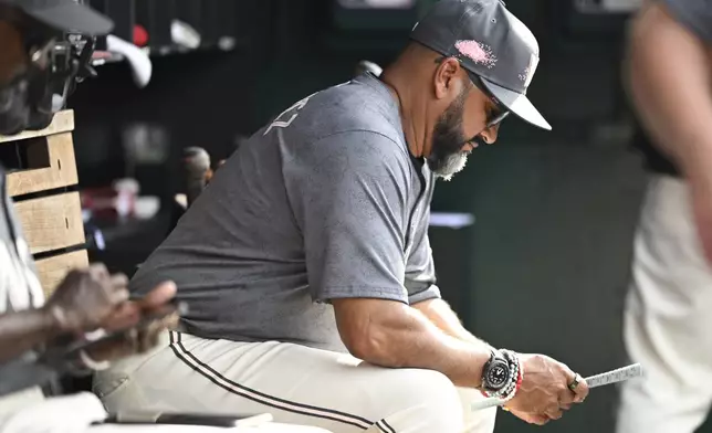Washington Nationals manager Dave Martinez studies his lineup card during the sixth inning of a baseball game, Saturday, May 25, 2024, in Washington. (AP Photo/John McDonnell)