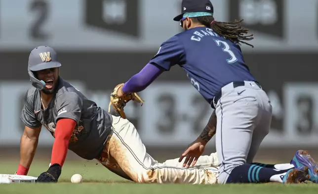 Washington Nationals' Luis Garcia Jr., left, is safe while stealing second base after Seattle Mariners shortstop J.P. Crawford (3) dropped the ball while making a tag during the second inning of a baseball game, Saturday, May 25, 2024, in Washington. (AP Photo/John McDonnell)