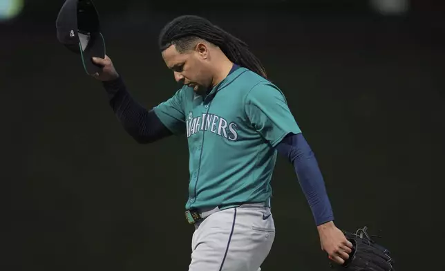 Seattle Mariners starter Luis Castillo walks back to the dugout after a pitching change during the seventh inning of a baseball game against the Minnesota Twins, Monday, May 6, 2024, in Minneapolis. (AP Photo/Abbie Parr)