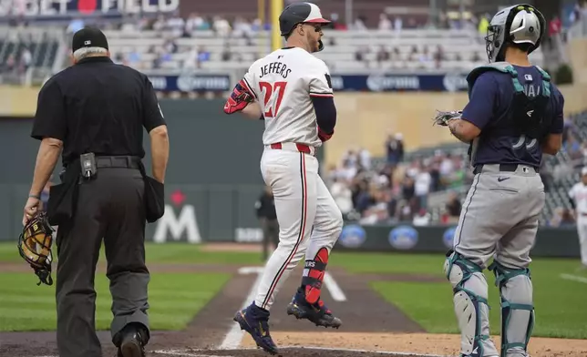 Minnesota Twins' Ryan Jeffers (27) crosses home plate after hitting a 3-run home run during the third inning of a baseball game against the Seattle Mariners, Tuesday, May 7, 2024, in Minneapolis. (AP Photo/Abbie Parr)