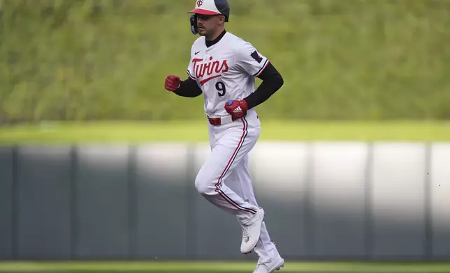 Minnesota Twins' Trevor Larnach runs the bases after hitting a solo home run against the Seattle Mariners during the first inning of a baseball game Wednesday, May 8, 2024, in Minneapolis. (AP Photo/Abbie Parr)