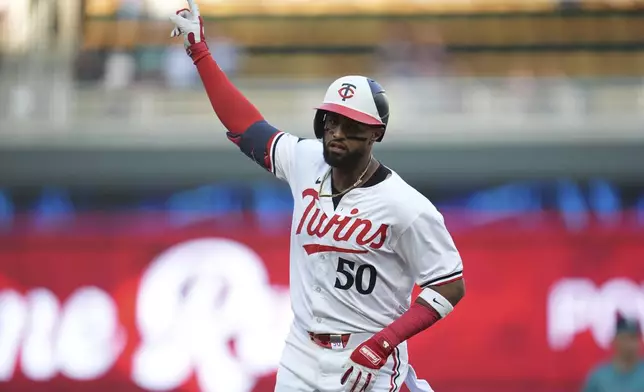 Minnesota Twins' Willi Castro (50) points while running the bases on a solo home run against the Seattle Mariners during the second inning of a baseball game Wednesday, May 8, 2024, in Minneapolis. (AP Photo/Abbie Parr)