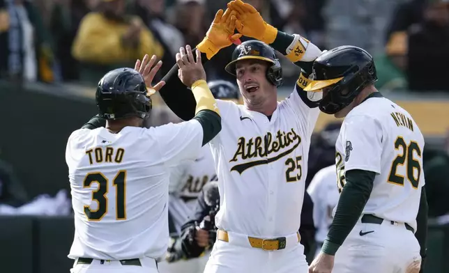 Oakland Athletics' Brent Rooker (25) celebrates with Abraham Toro (31) and Tyler Nevin (26) after hitting a three-run home run against the Miami Marlins during the third inning of a baseball game Saturday, May 4, 2024, in Oakland, Calif. (AP Photo/Godofredo A. Vásquez)