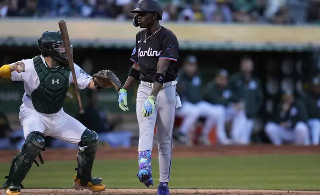 Miami Marlins' Jazz Chisholm Jr., right, reacts after striking out against Oakland Athletics pitcher JP Sears during the fourth inning of a baseball game Friday, May 3, 2024, in Oakland, Calif. (AP Photo/Godofredo A. Vásquez)