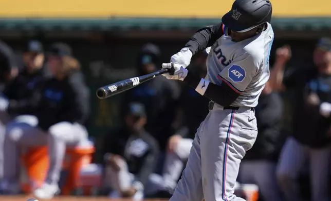 Miami Marlins' Nick Gordon hits a single against the Oakland Athletics during the ninth inning of a baseball game, Sunday, May 5, 2024, in Oakland, Calif. (AP Photo/Godofredo A. Vásquez)