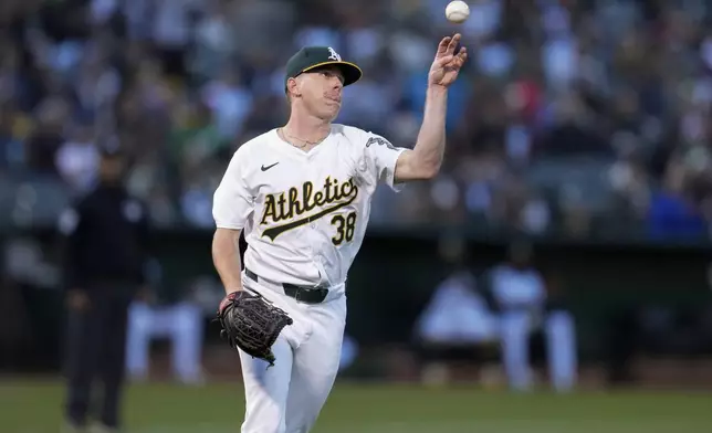 Oakland Athletics pitcher JP Sears throws to first base for the out on Miami Marlins' Josh Bell during the fourth inning of a baseball game Friday, May 3, 2024, in Oakland, Calif. (AP Photo/Godofredo A. Vásquez)