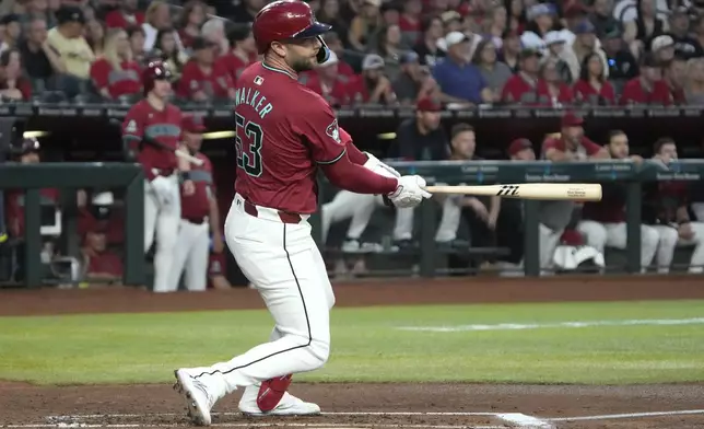 Arizona Diamondbacks' Christian Walker watches his RBI double against the Miami Marlins during the first inning of a baseball game Saturday, May 25, 2024, in Phoenix. (AP Photo/Rick Scuteri)