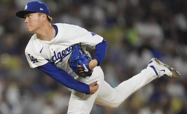 Los Angeles Dodgers pitcher Yoshinobu Yamamoto follows through on a pitch to a Miami Marlins batter during the fourth inning of a baseball game Tuesday, May 7, 2024, in Los Angeles. (AP Photo/Marcio Jose Sanchez)