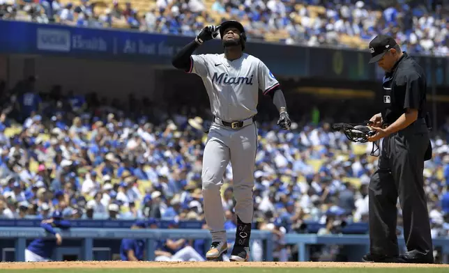 Miami Marlins' Bryan De La Cruz gestures as he scores after hitting a solo home run during the fourth inning of a baseball game against the Los Angeles Dodgers Wednesday, May 8, 2024, in Los Angeles. (AP Photo/Mark J. Terrill)