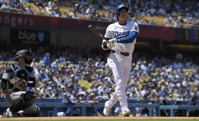 Los Angeles Dodgers designated hitter Shohei Ohtani takes a strike as Miami Marlins catcher Nick Fortes kneels behind the plate during the eighth inning of a baseball game Wednesday, May 8, 2024, in Los Angeles. (AP Photo/Mark J. Terrill)