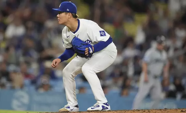 Los Angeles Dodgers pitcher Yoshinobu Yamamoto follows through on a pitch to a Miami Marlins batter during the eighth inning of a baseball game Tuesday, May 7, 2024, in Los Angeles. (AP Photo/Marcio Jose Sanchez)