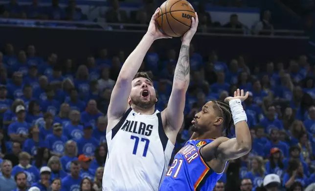Dallas Mavericks guard Luka Doncic (77) goes up for a shot against Oklahoma City Thunder guard Aaron Wiggins (21) during the first half in Game 2 of an NBA basketball second-round playoff series, Thursday, May 9, 2024, in Oklahoma City. (AP Photo/Kyle Phillips)