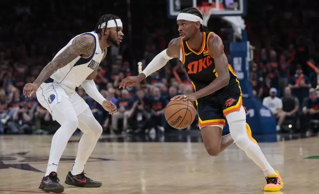 Oklahoma City Thunder guard Shai Gilgeous-Alexander, right, drives against Dallas Mavericks guard Jaden Hardy during the second half of Game 5 of an NBA basketball second-round playoff series, Wednesday, May 15, 2024, in Oklahoma City. (AP Photo/Nate Billings)