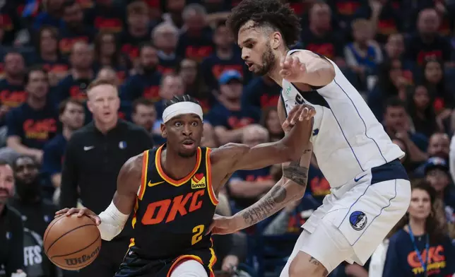 Oklahoma City Thunder guard Shai Gilgeous-Alexander, left, works the floor against Dallas Mavericks center Dereck Lively II during the second half of Game 5 of an NBA basketball second-round playoff series, Wednesday, May 15, 2024, in Oklahoma City. (AP Photo/Nate Billings)