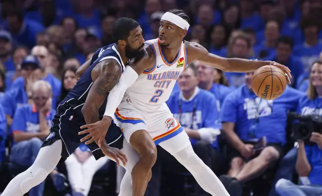 Oklahoma City Thunder guard Shai Gilgeous-Alexander (2) works the floor against Dallas Mavericks guard Kyrie Irving during the first half of Game 1 of an NBA basketball second-round playoff series, Tuesday, May 7, 2024, in Oklahoma City. (AP Photo/Nate Billings)