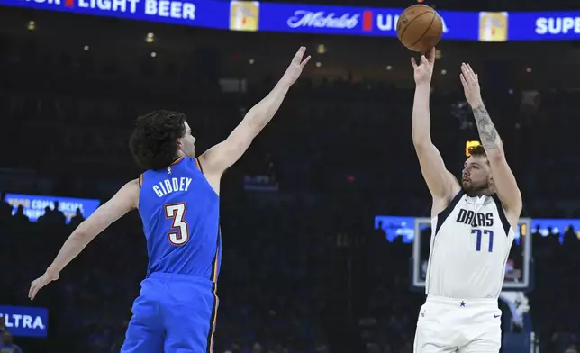 Dallas Mavericks guard Luka Doncic, right, shoots against Oklahoma City Thunder guard Josh Giddey during the first half in Game 2 of an NBA basketball second-round playoff series, Thursday May 9, 2024, in Oklahoma City. (AP Photo/Kyle Phillips)