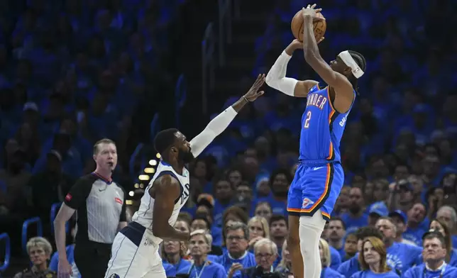Oklahoma City Thunder guard Shai Gilgeous-Alexander, right, shoots against Dallas Mavericks forward Tim Hardaway Jr. during the first half in Game 2 of an NBA basketball second-round playoff series, Thursday, May 9, 2024, in Oklahoma City. (AP Photo/Kyle Phillips)
