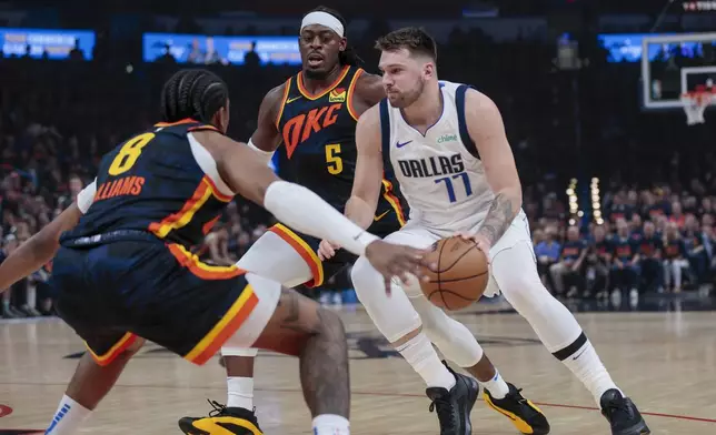 Dallas Mavericks guard Luka Doncic (77) drives against Oklahoma City Thunder forward Jalen Williams (8) and guard Luguentz Dort (5) during the first half of Game 5 of an NBA basketball second-round playoff series, Wednesday, May 15, 2024, in Oklahoma City. (AP Photo/Nate Billings)