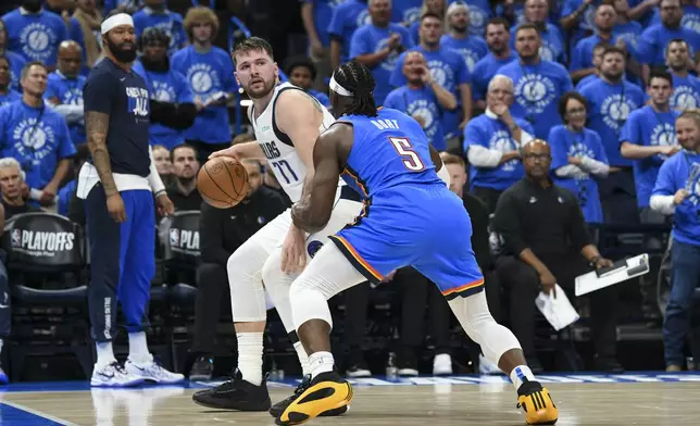 Dallas Mavericks guard Luka Doncic (77) works the floor against Oklahoma City Thunder guard Luguentz Dort (5) during the first half in Game 2 of an NBA basketball second-round playoff series, Thursday, May 9, 2024, in Oklahoma City. (AP Photo/Kyle Phillips)
