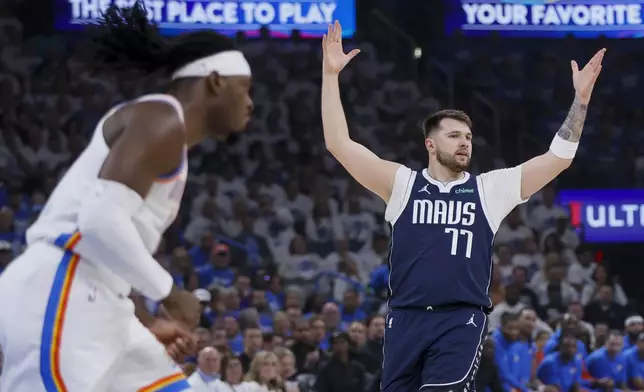 Dallas Mavericks guard Luka Doncic, right, reacts as Oklahoma City Thunder guard Luguentz Dort looks on during the first half of Game 1 of an NBA basketball second-round playoff series, Tuesday, May 7, 2024, in Oklahoma City. (AP Photo/Nate Billings)