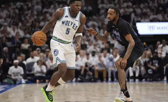 Minnesota Timberwolves guard Anthony Edwards (5) drives against Dallas Mavericks forward Derrick Jones Jr. (55) during the second half of Game 2 of the NBA basketball Western Conference finals, Friday, May 24, 2024, in Minneapolis. (AP Photo/Abbie Parr)