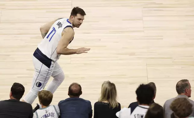 Dallas Mavericks guard Luka Doncic celebrates his made 3-pointer against the Minnesota Timberwolves during the first half of Game 5 of the Western Conference finals in the NBA basketball playoffs, Thursday, May 30, 2024, in Minneapolis. (AP Photo/Matt Krohn)