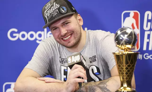 Dallas Mavericks guard Luka Doncic smiles during a news conference after the team's win over the Minnesota Timberwolves in Game 5 of the NBA basketball Western Conference finals Thursday, May 30, 2024, in Minneapolis. (AP Photo/Matt Krohn)