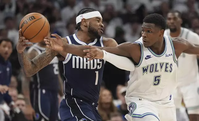 Dallas Mavericks guard Jaden Hardy (1) is defended by Minnesota Timberwolves guard Anthony Edwards (5) during the second half in Game 1 of the NBA basketball Western Conference finals, Wednesday, May 22, 2024, in Minneapolis. (AP Photo/Abbie Parr)
