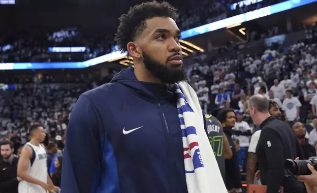 Minnesota Timberwolves center Karl-Anthony Towns walks off the court after Game 5 of the team's NBA basketball Western Conference finals against the Dallas Mavericks, Thursday, May 30, 2024, in Minneapolis. Dallas won 124-103, advancing to the NBA Finals. (AP Photo/Abbie Parr)