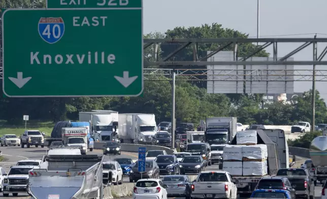 Motorists travel along Interstate 24 near the Interstate 40 interchange Thursday, May 23, 2024, in Nashville, Tenn. A record number of Americans are expected to hit the pavement over the 2024 Memorial Day holiday. (AP Photo/George Walker IV)