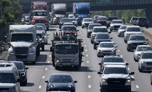 Motorists travel westbound along Interstate 40, Thursday, May 23, 2024, in Nashville, Tenn. A record number of Americans are expected to hit the pavement over the 2024 Memorial Day holiday. (AP Photo/George Walker IV)