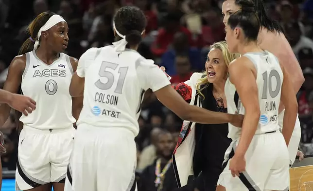 Las Vegas Aces head coach Becky Hammon speaks with her players during the second half of a WNBA basketball game against the Phoenix Mercury, Tuesday, May 14, 2024, in Las Vegas. (AP Photo/John Locher)