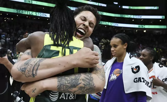 FILE - Phoenix Mercury center Brittney Griner, center, hugs Seattle Storm guard Jewell Loyd, left, after a WNBA basketball game Saturday, June 24, 2023, at Climate Pledge Arena in Seattle. Life isn't what it once was for the perennial WNBA All-Star. (Kevin Clark/The Seattle Times via AP, File, Filer)