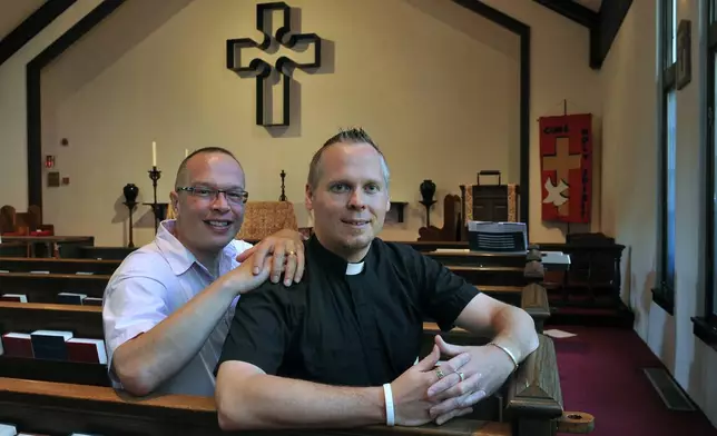 FILE - The Very Rev. Christopher D. Hofer, right and his partner of 17 years, Kerry Brady at Hofer's parish, the Episcopal Church of St. Jude on Thursday, July 14, 2011 in Wantagh, N.Y., where they plan to wed in August. When the United Methodist Church removed anti-LGBTQ language from its official rules in recent days, it marked the end of a half-century of debates over LGBTQ inclusion in mainline Protestant denominations. The moves sparked joy from progressive delegates, but the UMC faces many of the same challenges as Lutheran, Presbyterian and Episcopal denominations that took similar routes, from schisms to friction with international churches to the long-term aging and shrinking of their memberships. (AP Photo/Kathy Kmonicek)