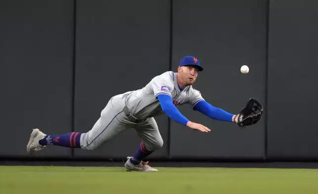 New York Mets center fielder Brandon Nimmo dives and catches a fly ball by St. Louis Cardinals' Nolan Gorman for an out during the fourth inning of a baseball game Tuesday, May 7, 2024, in St. Louis. (AP Photo/Jeff Roberson)