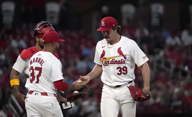 St. Louis Cardinals starting pitcher Miles Mikolas (39) is removed by manager Oliver Marmol (37) during the fifth inning of a baseball game against the New York Mets Tuesday, May 7, 2024, in St. Louis. (AP Photo/Jeff Roberson)