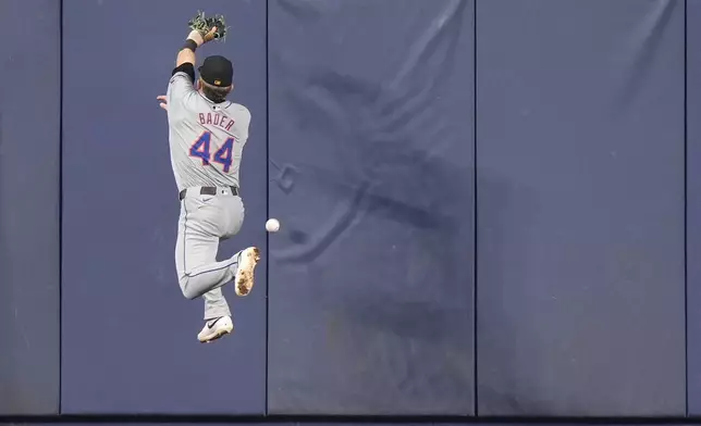 New York Mets center fielder Harrison Bader is unable to catch a ball hit by Miami Marlins' Josh Bell for a double, during the first inning of a baseball game, Sunday, May 19, 2024, in Miami. (AP Photo/Wilfredo Lee)