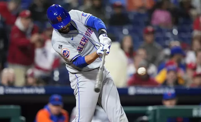 New York Mets' J.D. Martinez hits a home run against Philadelphia Phillies pitcher Spencer Turnbull during the eighth inning of a baseball game, Wednesday, May 15, 2024, in Philadelphia. (AP Photo/Matt Slocum)