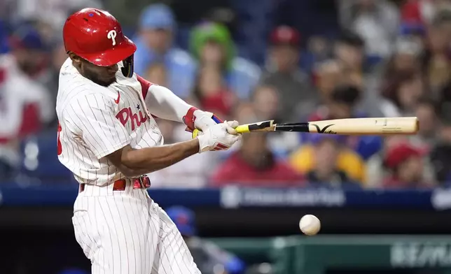 Philadelphia Phillies' Johan Rojas breaks his bat on a run-scoring single against New York Mets pitcher Adrian Houser during the seventh inning of a baseball game, Wednesday, May 15, 2024, in Philadelphia. (AP Photo/Matt Slocum)