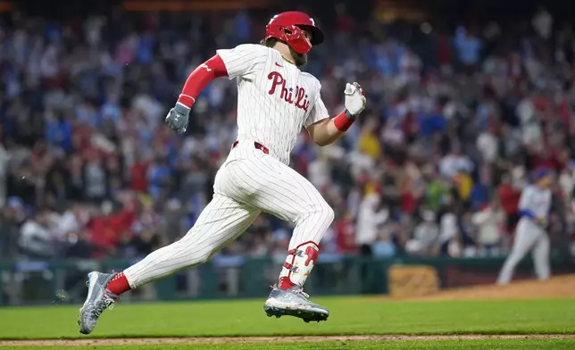 Philadelphia Phillies' Bryce Harper runs after hitting a two-run double against New York Mets pitcher Joey Lucchesi during the fifth inning of a baseball game, Wednesday, May 15, 2024, in Philadelphia. (AP Photo/Matt Slocum)