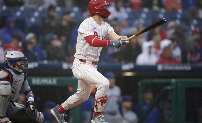 Philadelphia Phillies' Bryce Harper follows through after hitting a home run against New York Mets pitcher Joey Lucchesi during the first inning of a baseball game, Wednesday, May 15, 2024, in Philadelphia. (AP Photo/Matt Slocum)