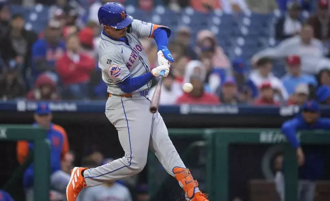 New York Mets' Mark Vientos hits a run-scoring double against Philadelphia Phillies pitcher Ranger Suarez during the first inning of a baseball game, Wednesday, May 15, 2024, in Philadelphia. (AP Photo/Matt Slocum)