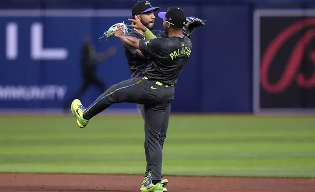 Tampa Bay Rays' Richie Palacios (1) and Jose Caballero celebrate after the team defeated the New York Mets during a baseball game Saturday, May 4, 2024, in St. Petersburg, Fla. (AP Photo/Chris O'Meara)