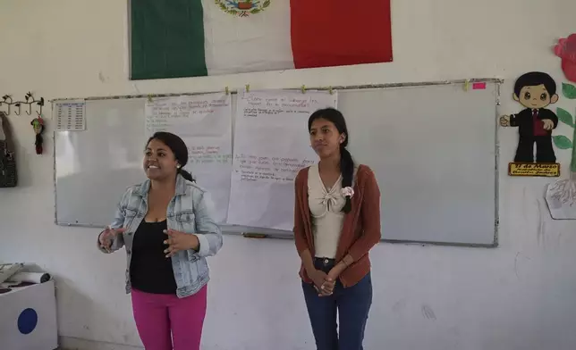 Liz Vázquez, left, speaks and Maria Leticia Santiz translates into the Tojolabal language, during a workshop with a co-ed class about gender equality at a school in Plan de Ayala, a Tojolabal village in the Las Margaritas municipality of Chiapas state, Mexico, Thursday, May 2, 2024. Vázquez and Santiz aim to encourage conversation and reflection in some of Chiapas’ most closed communities, learn the realities of people there, and provide tools to improve their lives. (AP Photo/Marco Ugarte)
