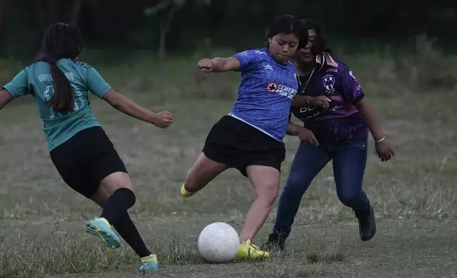 Madaí Gómez, center, plays soccer in Plan de Ayala, a Tojolabal village in the Las Margaritas municipality of Chiapas state, Mexico, Thursday, May 2, 2024. Gómez said she believes in the potential of women in her community and thinks Mexico’s first woman president could show they can do more even than men: “She could do a better job than anyone else.” (AP Photo/Marco Ugarte)