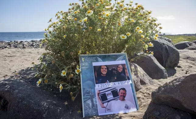 The photos of the foreign surfers who disappeared are placed on the beach in Ensenada, Mexico, Sunday, May 5, 2024. Mexican authorities said Friday that three bodies were recovered in an area of Baja California near where two Australians and an American went missing last weekend during an apparent camping and surfing trip. (AP Photo/Karen Castaneda)