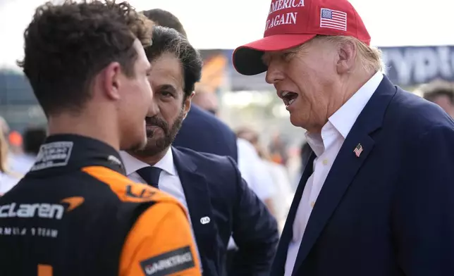 Republican presidential candidate former President Donald Trump, right, talks with McLaren driver Lando Norris, left, of Britain, after Norris won the Miami Formula One Grand Prix auto race Sunday, May 5, 2024, in Miami Gardens, Fla. (AP Photo/Rebecca Blackwell)