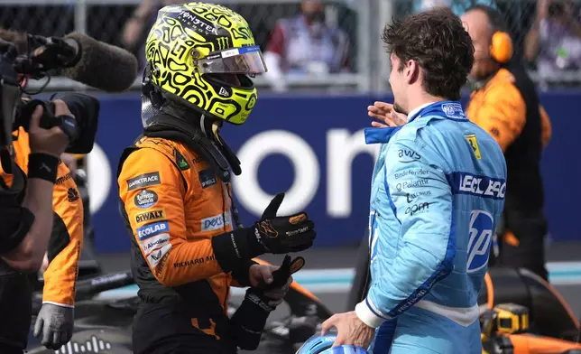 McLaren driver Lando Norris, left, of Britain, shakes hands with Ferrari driver Charles Leclerc, of Monaco, after winning the Miami Formula One Grand Prix auto race Sunday, May 5, 2024, in Miami Gardens, Fla. (AP Photo/Rebecca Blackwell)