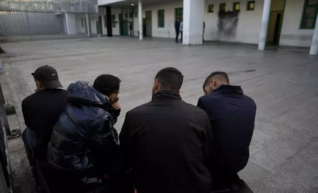 Detainees gather in an open area of the Ponte Galeria center, one of the facilities created in Italy to hold migrants ahead of their repatriation, as they are considered ineligible for refugee status or international protection, in Rome, Tuesday, March 19, 2024. (AP Photo/Andrew Medichini)